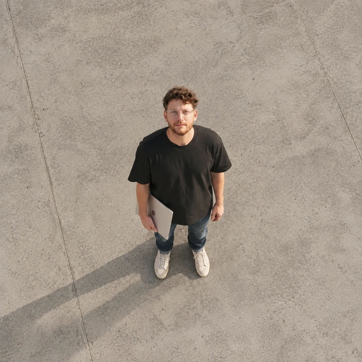 Ezequiel Pavlotsky, founder of Miami Pixel, photographed from above holding a laptop